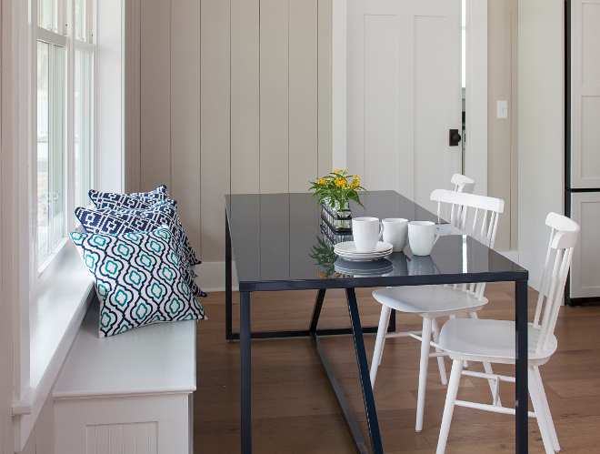 Breakfast Nook Banquette. Simple breakfast nook with built in banquette, hardwood floors and vertical shiplap painted in a neutral creamy color, Sherwin Williams Only Natural #breakfastnook #sherwinwilliamsonlynatural #shiplap #hardwoodfloors #verticalshiplap #banquette Lisa Furey - Barefoot Interiors