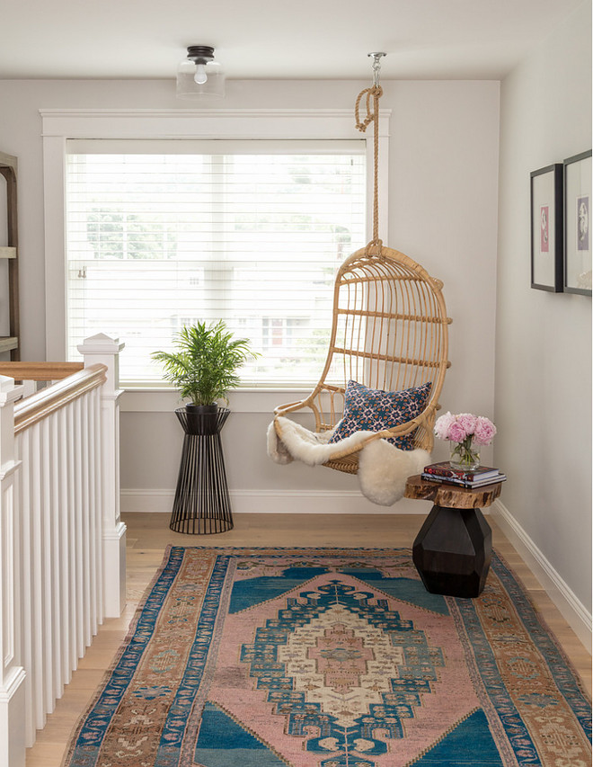 Hanging Rattan Chair. Landing area with Hanging Rattan Chair. Cozy landing area nook with hanging rattan chair and Turkish rug. Great spot to read a book. Hanging Rattan Chair #HangingRattanChair #swingchair Jamie Keskin Design