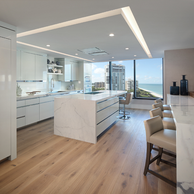 Modern White Kitchen. Sleek Modern White Kitchen. This kitchen is the epitome of crisp, clean and contemporary. My favorite parts- the porcelain countertops (great scratch-proof, durable material) and the custom, nearly transparent cabinetry. Modern White Kitchen #ModernWhiteKitchen W Design