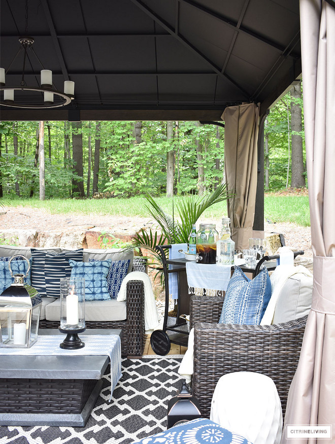 outdoor-gazebo-with-wicker-furniture-and-fire-table-decorated-with-blue-and-white-accents Beautiful Homes of Instagram @citrineliving Home Bunch