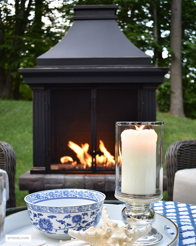 outdoor-patio-fireplace-lounge-area-mercury-glass-hurricane-candle-blue-and-white-decor Home Bunch Beautiful Homes of Instagram @citrineliving