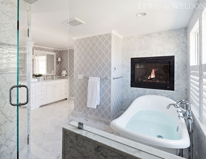 Bathoom features a combination of grey wallpaper and Carrara marble tile. Grey wallpaper is Thibaut Stanbury Trellis, color Grey. Lewis & Weldon Custom Kitchens