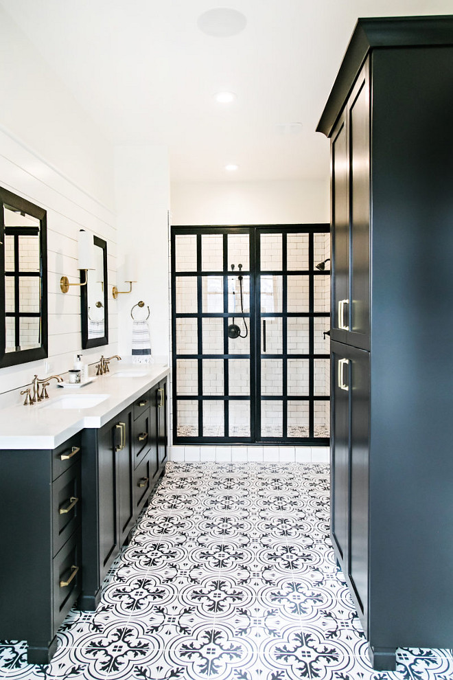 Black Beauty by Benjamin Moore. Black Beauty by Benjamin Moore Farmhouse bathroom with black cabinets, painted in Black Beauty by Benjamin Moore, custom framed shower doors and black and white tile. Rather than installing pricey cement tile, the designer used porcelain tiles that features the same designs but it's much more affordable and low-maintenance. #BlackBeautybyBenjaminMoore Sita Montgomery Interiors