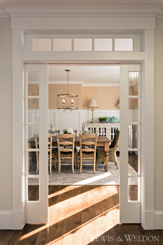 Dining room glass pocket doors and transoms. These glass pocket doors and transoms creates a sense of intimacy to this dining room. #Diningroom #glasspocketdoors #transoms Lewis & Weldon Custom Kitchens