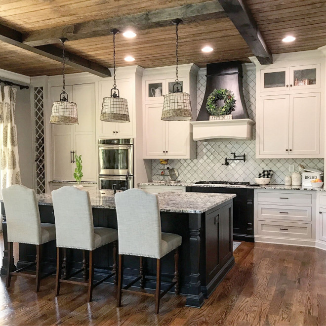 Farmhouse kitchen with white cabinets, black island and beamed V-Groove Pine Plank ceiling. Farmhouse kitchen with white cabinets, black island and beamed V-Groove Pine Plank ceiling. Farmhouse kitchen with white cabinets, black island and beamed V-Groove Pine Plank ceiling #Farmhousekitchen #whitecabinets #blackisland #beamedceiling # VGroovePinePlank #plankceiling Home Bunch Beautiful Homes of Instagram @mygeorgiahouse