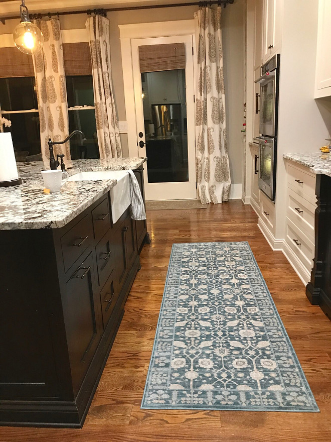 Kitchen Runner. Blue and white kitchen runner. Farmhouse kitchen with black island, hardwood floors and blue and White kitchen runner #kitchenrunner Home Bunch Beautiful Homes of Instagram @mygeorgiahouse