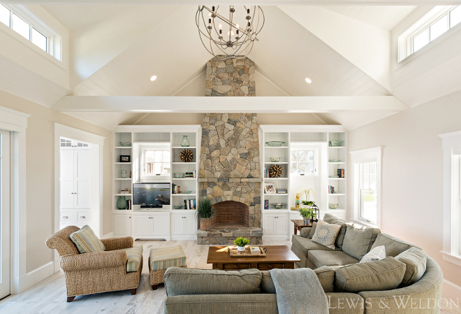 Living room with vaulted ceiling and stone fireplace. Lewis & Weldon Custom Kitchens