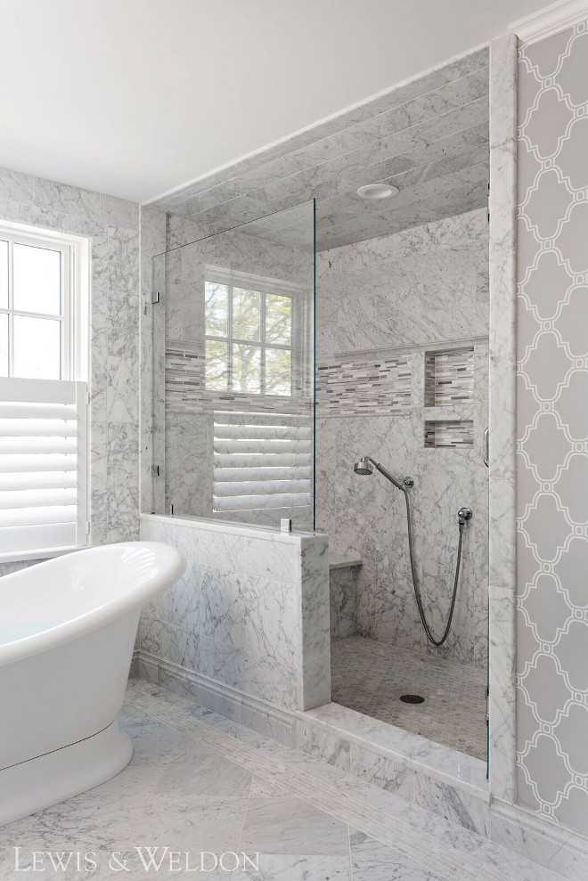 Marble Shower Tile. This shower features different sizes of Carrara marble tile from floor to ceiling. #bathroom #shower #marbletile #carrara Lewis & Weldon Custom Kitchens