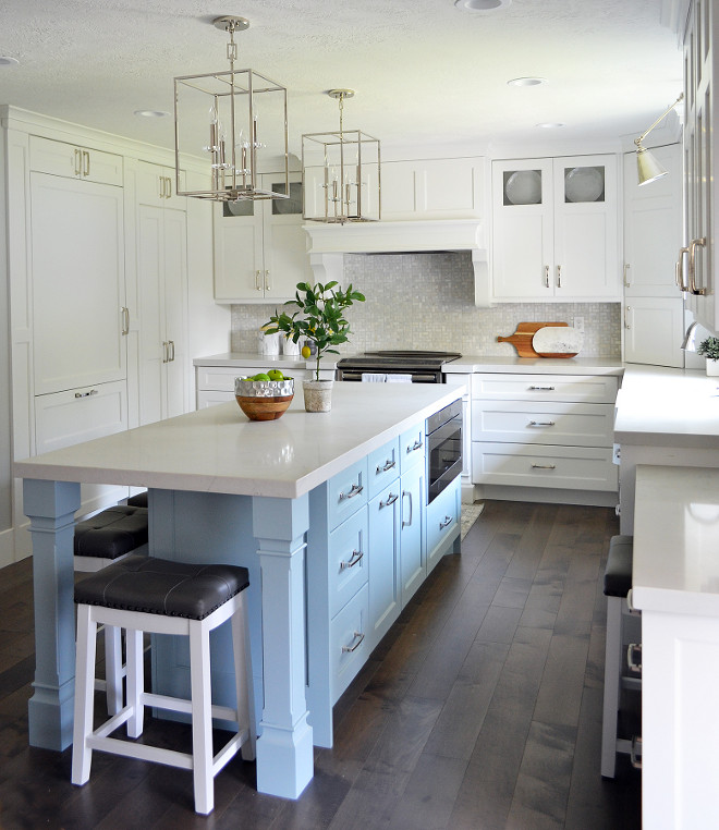 Kitchen with narrow and long island. White kitchen with a long and narrow kitchen island painted in a light turquoise blue color and white quartz countertop. #kitchen #narrowisland #narrowkitchenisland #longkitchenisland #whitequartz #countertop #turquoisekitchenisland Sita Montgomery Interiors