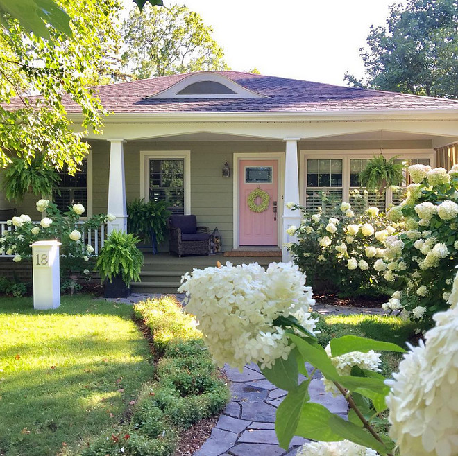 Cottage with porch and pink front door Siding is James Hardie Heathered Moss #JamesHardieHeatheredMoss #cottage #frontporch #pinkfrontdoor #pink #door