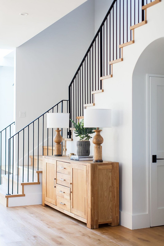 Farmhouse Foyer Modern farmhouse foyer features a custom staircase with wrought iron stair railing