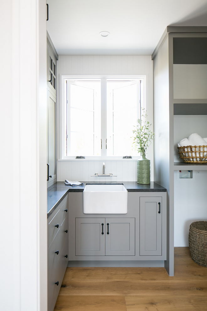 Grey laundry room with small farmhouse sink This grey laundry room features a small farmhouse sink and honed Belgian Limestone countertop
