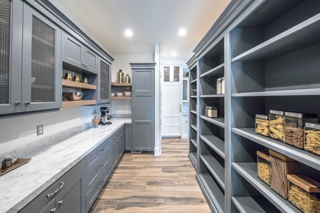 Grey pantry. Walk in pantry with grey cabinets. This home also features a walk-in pantry with grey cabinets and Carrara marble countertop. Grey pantry #Grey #pantry Tree Haven Homes & Danielle Loryn Design