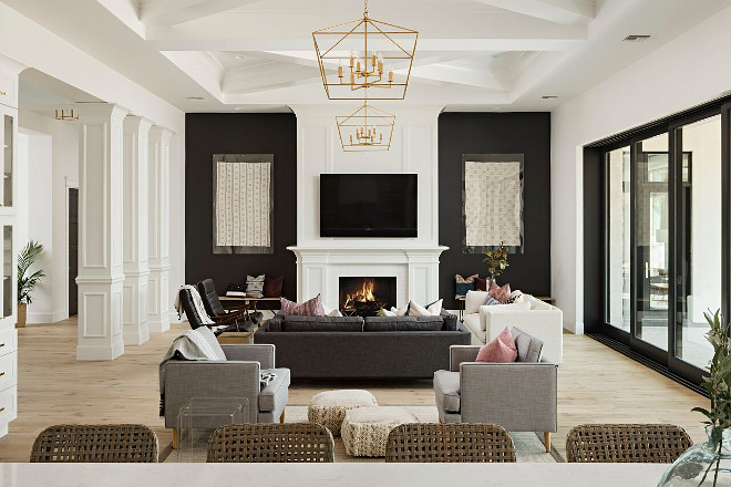 A large great room is the perfect place to entertain friends and family. The great room features 14 foot decorative ceilings and black accent walls on either side of the Isokern fireplace selected by the interior designer. A Finer Touch Construction