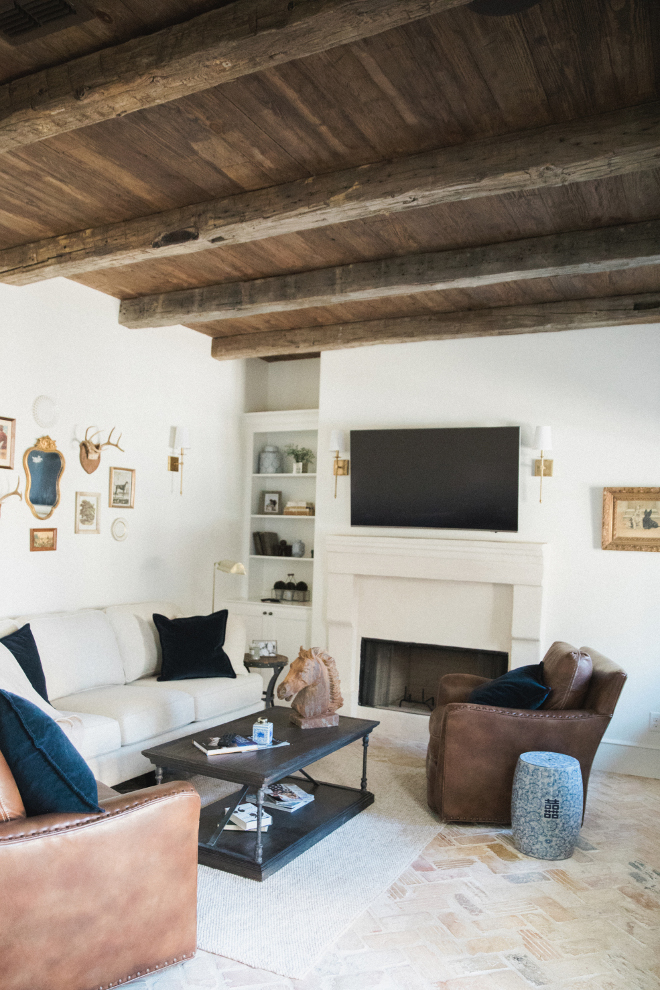 Rustic Den with reclaimed wood ceiling and brick flooring