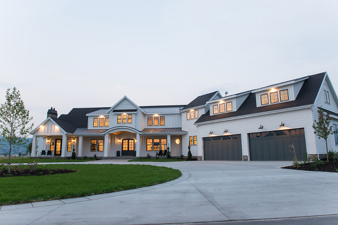 White modern farmhouse exterior with grey garage doors and grey front door