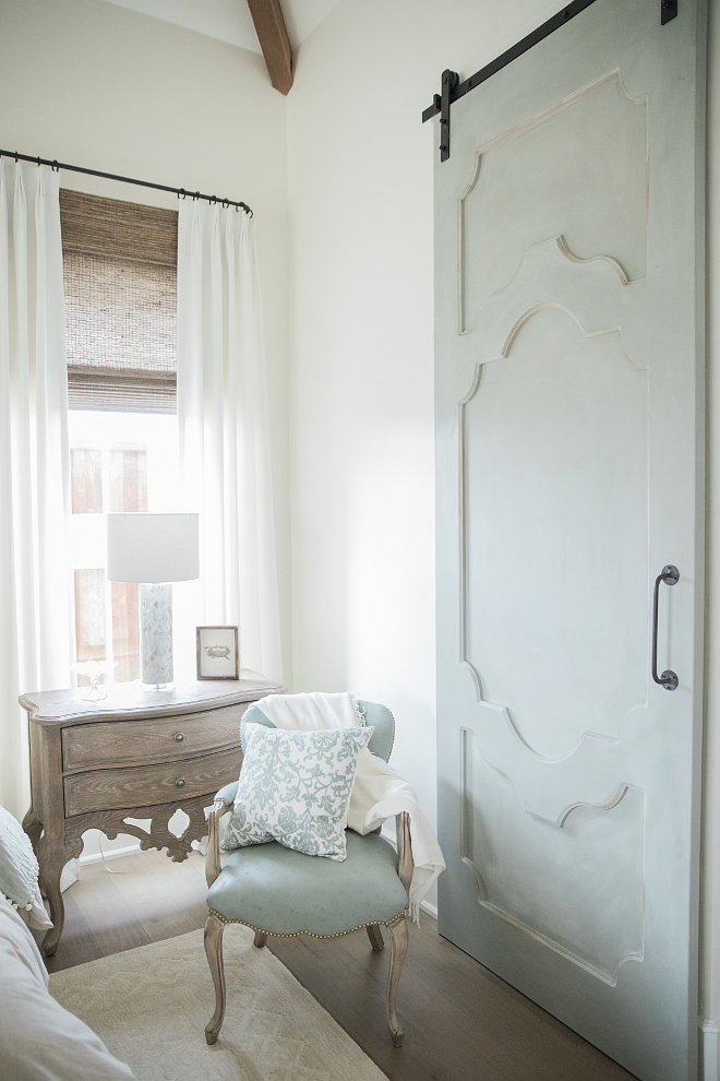 The barn door is a custom designed door from a local carpenter and painted by the designer in Annie Sloan - custom mix of Duck Egg Blue, Old White, French Linen, and Coco