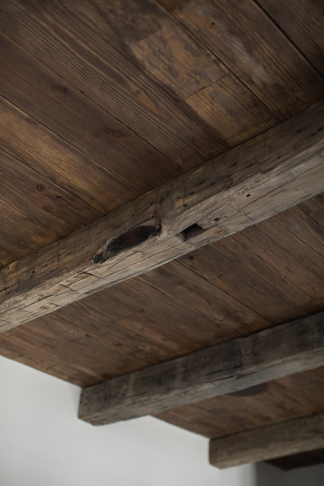reclaimed barn wood beams over regular cedar planks distressed with nails, chains, and hammers