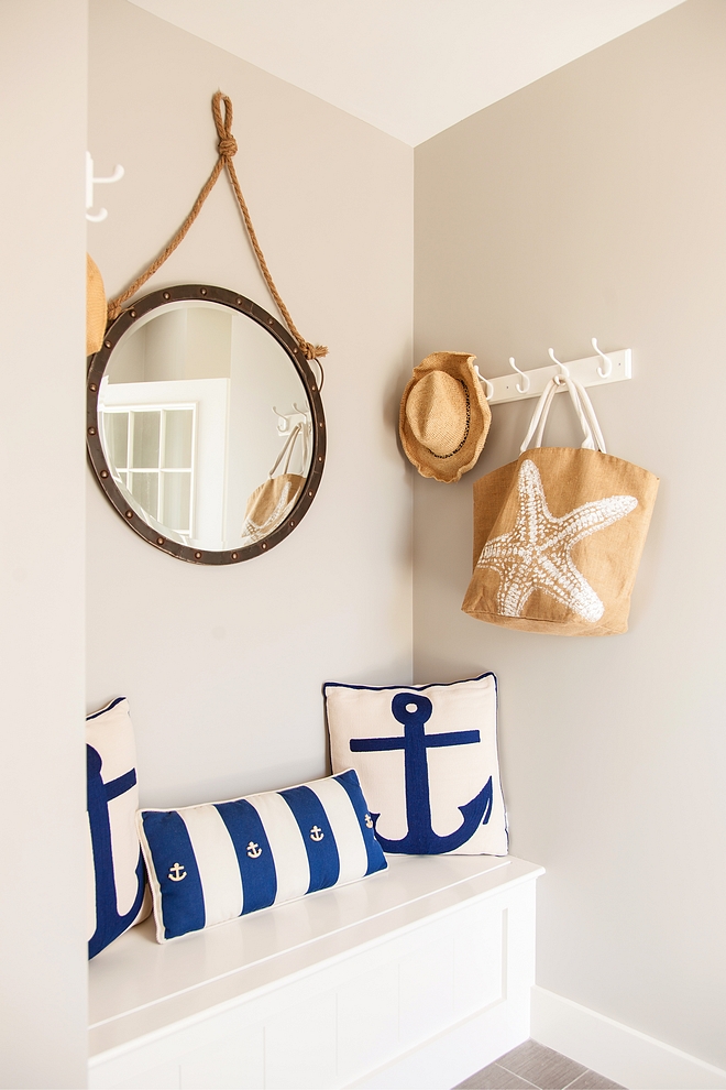 Coastal mudroom painted in Revere Pewter by Benjamin Moore and blue and white anchor pillows and round mirror with rope