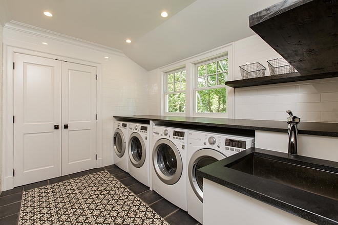 Laundry room Main laundry room features double set of washer and dryer Countertop is honed Black Granite