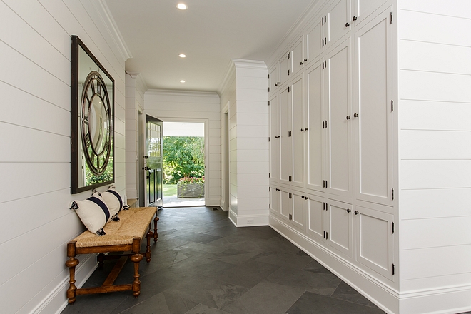 Gorgeous side entry and mudroom. I love the natural stone flooring and the shiplap
