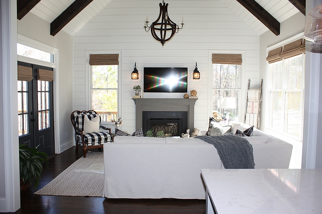 Great room with floor to ceiling shiplap vaulted ceiling and dark stained beams