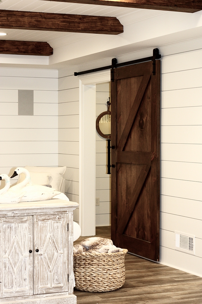 Custom-made barn door that opens and closes to the bunk room Shiplap and custom barn door