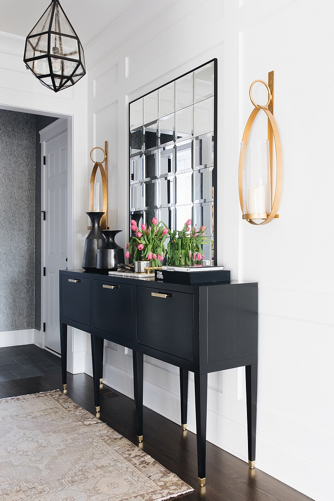 Foyer black console table This ebony console table brings personality and some contrast against the white paneling ebony console table back and white interiors
