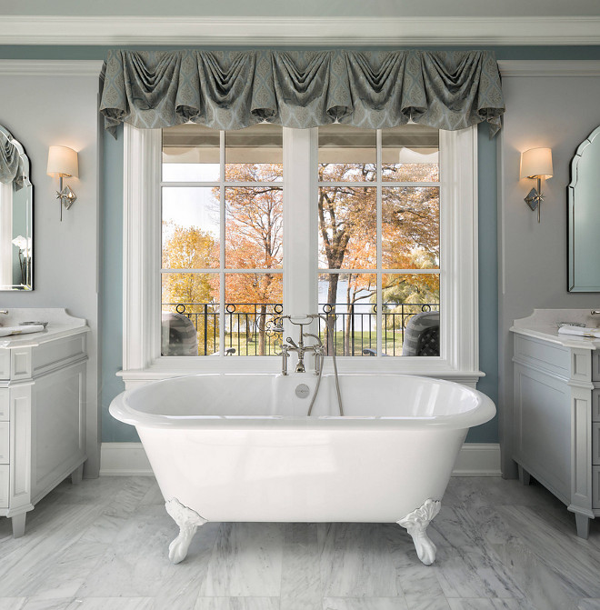 Traditional Bathroom with freestanding bathtub and window placed at eye level