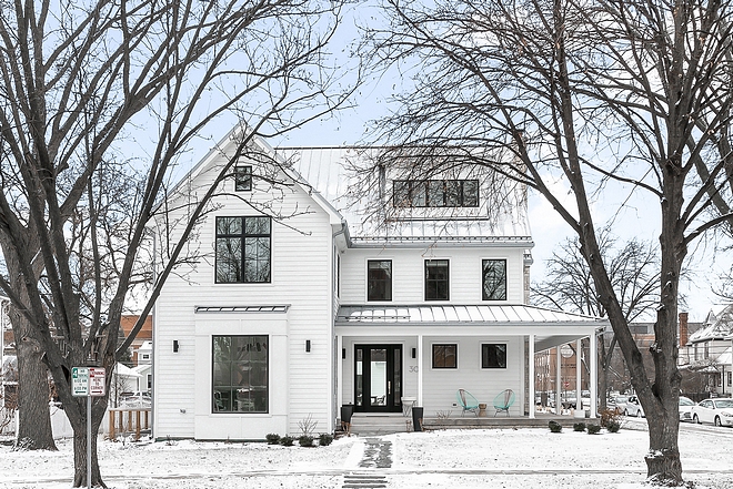 White farmhouse with black windows metal roof and black steel front door exterior modern farmhouse architecture