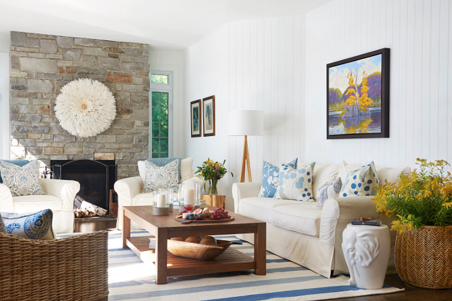 Country Coastal Living Room This country coastal living room sets the vibe for this lake cottage with colorful decor, vertical shiplap and that gorgeous stone fireplace