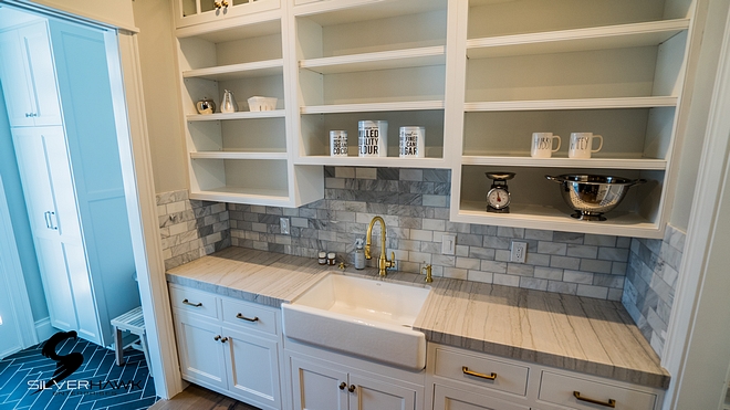 Butlers pantry with white quartzite countertop and marble subway tile sources on Home Bunch