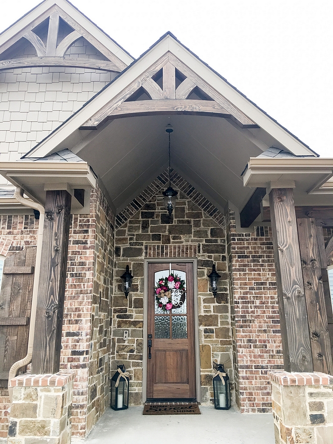 Brick and stone exterior with Timber wood columns and Timber Trusses front entry porch