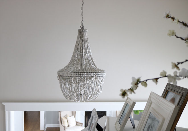 Grey Beaded Chandelier Whitewashed wood beads give the Francesca Chandelier a fresh, summery look Whether in a dining room or a seating area, it’s a natural complement to any decor style #chandelier #beadedchandelier #graywash