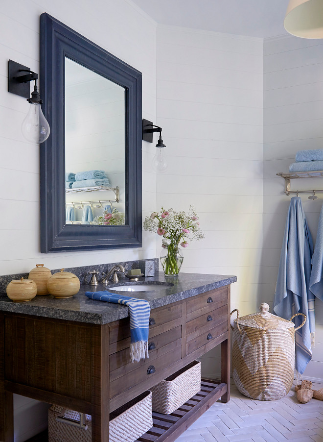 Reclaimed Wood Bathroom Vanity Bathroom features a vanity made of reclaimed wood with granite countertop, Riverrock Granite, shiplap wall paneling and herringbone floor tile