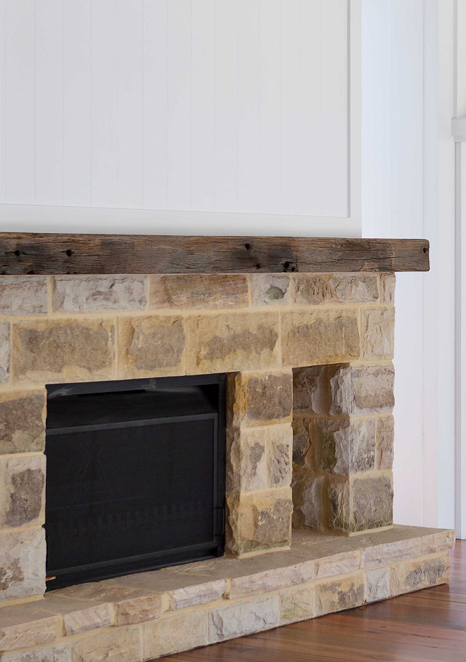 Stone Fireplace with Reclaimed Beam Large reclaimed sandstone blocks were used on the fireplace. These were salvaged from the previous home that was demolished A large recycled timber piece was used for the mantel #reclaimedbeam #fireplace #stonefireplace #reclaimedstone