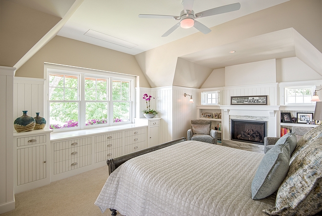Beadboard bedroom The homeowner liked the idea of irregular ceilings, reminiscent of grandmother ’s attic Recessed bookshelves flank a fireplace to create a cozy reading area Deep window boxes add a pop of color