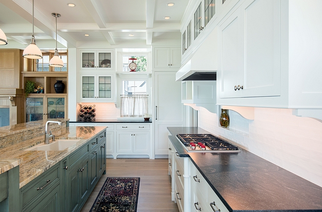Kitchen Ovens and freezer drawers were placed in the pantry freeing up space for storage under the cooktop and reducing the need for confining kitchen walls The variety of cabinet/counter finishes and asymmetrical lines contributes to a friendly informality