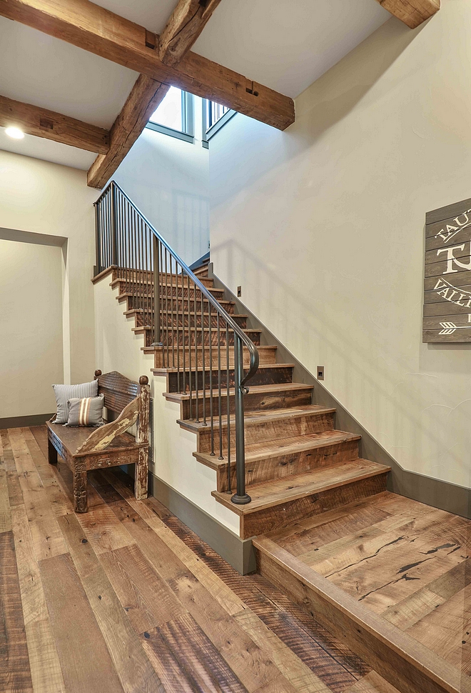 Reclaimed wood staircase with custom iron railing Reclaimed mixed hardwood flooring on a staircase #reclaimedwoodstaircase