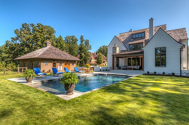 Backyard with pool Carriage house and painted brick home