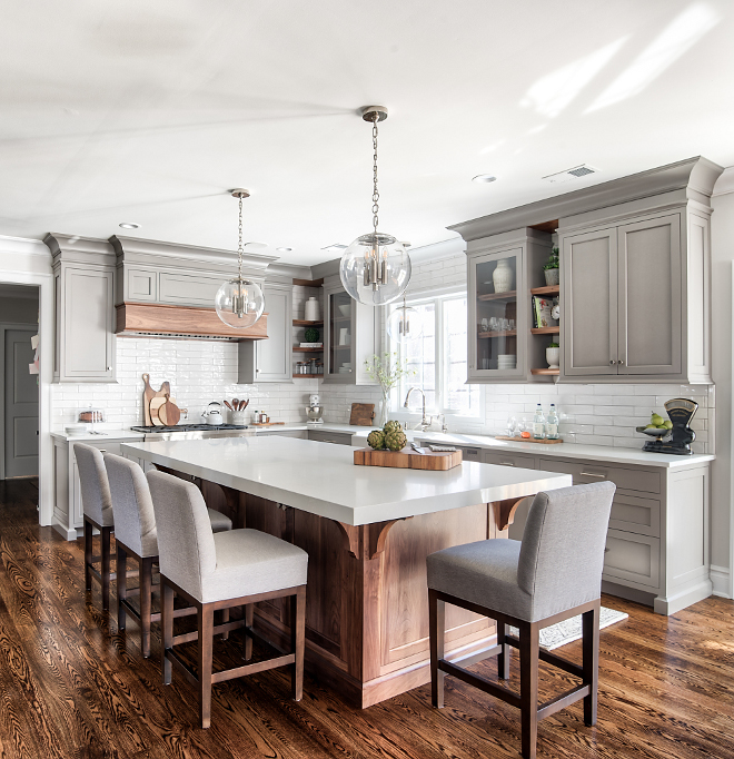 Grey Kitchen Beautiful grey kitchen with enlonged subway tile backsplash grey linen Counterstools clear glass globe lighting and Black Walnut kitchen island and Black Walnut hardwood floor #kitchen #greykitchen