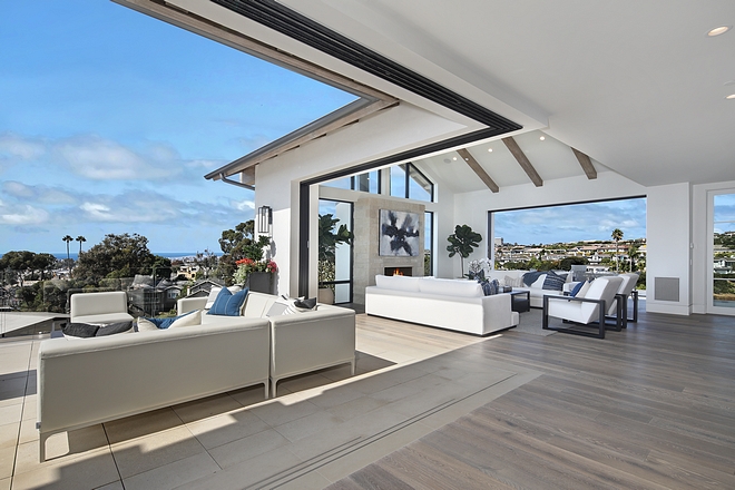 Living room Retractable patio doors open to the ocean view from the front deck with firepit and rear balcony