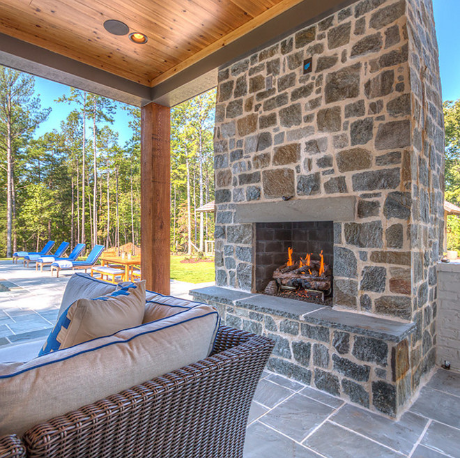 The back porch features an outdoor fireplace with grey natural stone