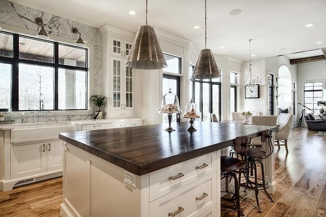 Kitchen island with Antique Nickel pendants industrial counterstools and butcher block countertop all sources on Home Bunch #kitchenisland #sources