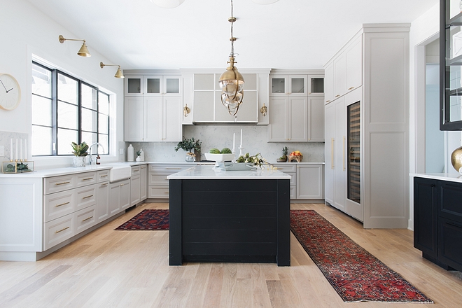 Modern farmhouse kitchen This modern farmhouse kitchen features plenty of cabinetry and large island with shiplap on the sides #modernfarmhouse #kitchen #modernfarmhousekitchen #island #kitchenisland #shiplapkitchenisland