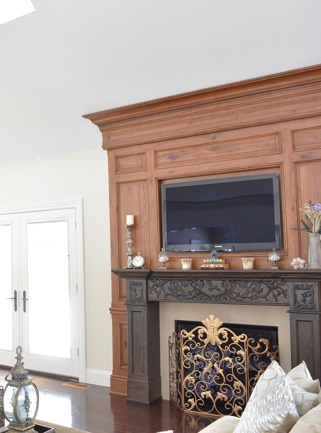 Traditional Fireplace Millwork featuring two-toned wood and detailed hand carvings