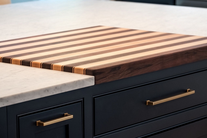 The butcher block cutting board was custom built by a local cabinet maker specifically for this home The cutting board features Walnut and Mable inlay - more details on Home Bunch