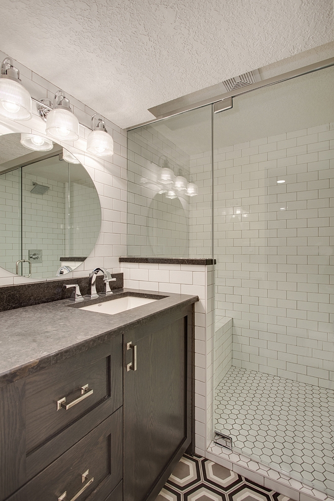 Basement Bathroom This basement bathroom has plenty of personality I especially like the shower with built-in bench and the affordable, yet timeless, tile choices Cabinet is Oak with black stain Basement Bathroom #Basement #Bathroom