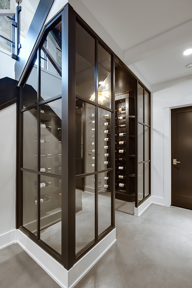 Wine Enclosure Wood and glass walls with glass door leads to the wine room #wineroom