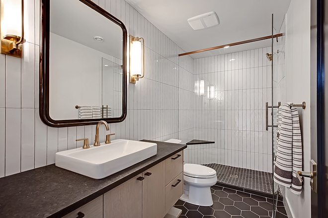 Basement Bathroom basement bathroom features heated 8” matte hexagon black tiles and leathered Black Granite countertop #basementbathroom #basement #bathroom